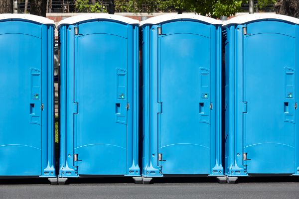 Porta potty delivery truck dropping off rental units in Austin